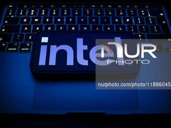 A laptop keyboard and Intel logo displayed on a smartphone are seen in this illustration photo taken in Krakow, Poland on December 21, 2024....