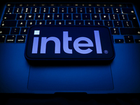 A laptop keyboard and Intel logo displayed on a smartphone are seen in this illustration photo taken in Krakow, Poland on December 21, 2024....