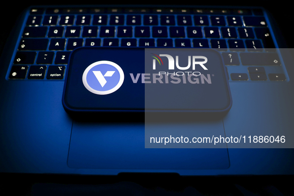 A laptop keyboard and Verisign logo displayed on a smartphone are seen in this illustration photo taken in Krakow, Poland on December 21, 20...