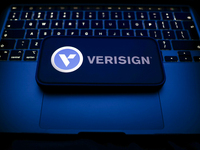 A laptop keyboard and Verisign logo displayed on a smartphone are seen in this illustration photo taken in Krakow, Poland on December 21, 20...