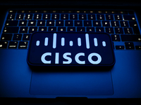 A laptop keyboard and Cisco logo displayed on a smartphone are seen in this illustration photo taken in Krakow, Poland on December 21, 2024....