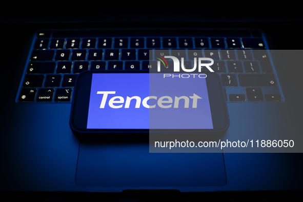 A laptop keyboard and Tencent logo displayed on a smartphone are seen in this illustration photo taken in Krakow, Poland on December 21, 202...