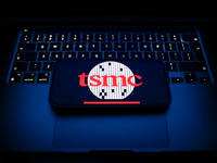 A laptop keyboard and TSMC logo displayed on a smartphone are seen in this illustration photo taken in Krakow, Poland on December 21, 2024....