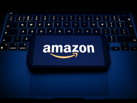 A laptop keyboard and Amazon logo displayed on a smartphone are seen in this illustration photo taken in Krakow, Poland on December 21, 2024...