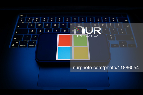 A laptop keyboard and Microsoft logo displayed on a smartphone are seen in this illustration photo taken in Krakow, Poland on December 21, 2...