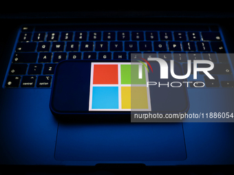 A laptop keyboard and Microsoft logo displayed on a smartphone are seen in this illustration photo taken in Krakow, Poland on December 21, 2...