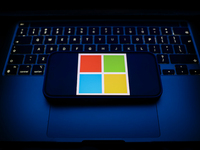 A laptop keyboard and Microsoft logo displayed on a smartphone are seen in this illustration photo taken in Krakow, Poland on December 21, 2...