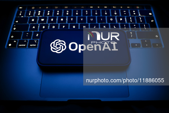 A laptop keyboard and OpenAI logo displayed on a smartphone are seen in this illustration photo taken in Krakow, Poland on December 21, 2024...