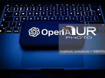 A laptop keyboard and OpenAI logo displayed on a smartphone are seen in this illustration photo taken in Krakow, Poland on December 21, 2024...