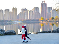 People run for fitness in low temperatures at Donghu Park in Zaozhuang, East China's Shandong province, on December 21, 2024. (