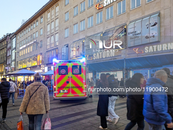 In Munich, Germany, on December 28, 2024, a Johanniter rescue vehicle with flashing blue lights parks on the shopping street Kaufinger Stras...