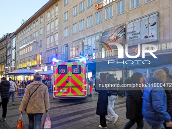 In Munich, Germany, on December 28, 2024, a Johanniter rescue vehicle with flashing blue lights parks on the shopping street Kaufinger Stras...