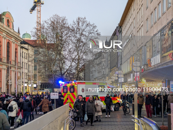 In Munich, Germany, on December 28, 2024, a Johanniter rescue vehicle with flashing blue lights parks on the shopping street Kaufinger Stras...