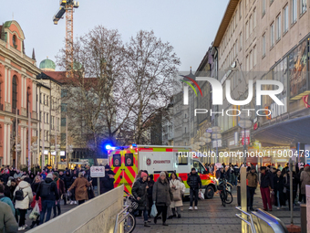 In Munich, Germany, on December 28, 2024, a Johanniter rescue vehicle with flashing blue lights parks on the shopping street Kaufinger Stras...