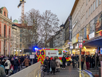 In Munich, Germany, on December 28, 2024, a Johanniter rescue vehicle with flashing blue lights parks on the shopping street Kaufinger Stras...