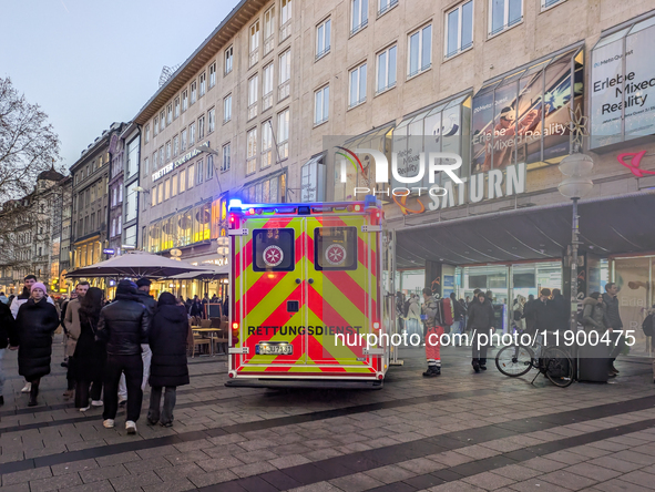 In Munich, Germany, on December 28, 2024, a Johanniter rescue vehicle with flashing blue lights parks on the shopping street Kaufinger Stras...