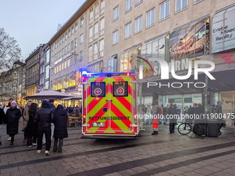 In Munich, Germany, on December 28, 2024, a Johanniter rescue vehicle with flashing blue lights parks on the shopping street Kaufinger Stras...