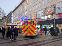 In Munich, Germany, on December 28, 2024, a Johanniter rescue vehicle with flashing blue lights parks on the shopping street Kaufinger Stras...