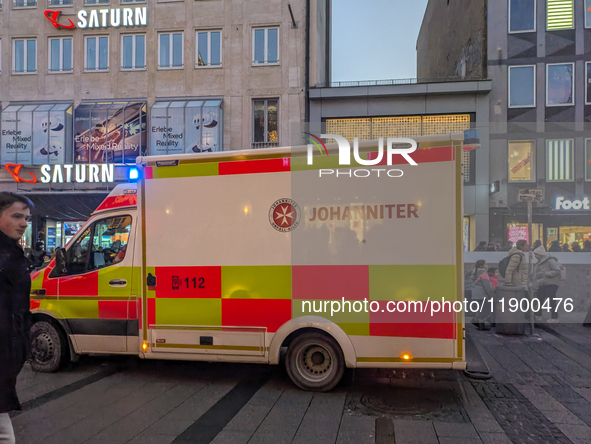 In Munich, Germany, on December 28, 2024, a Johanniter rescue vehicle with flashing blue lights parks on the shopping street Kaufinger Stras...