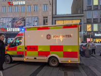 In Munich, Germany, on December 28, 2024, a Johanniter rescue vehicle with flashing blue lights parks on the shopping street Kaufinger Stras...