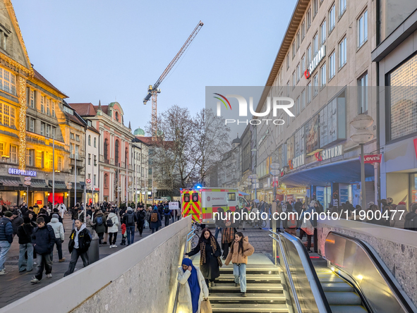 In Munich, Germany, on December 28, 2024, a Johanniter rescue vehicle with flashing blue lights parks on the shopping street Kaufinger Stras...