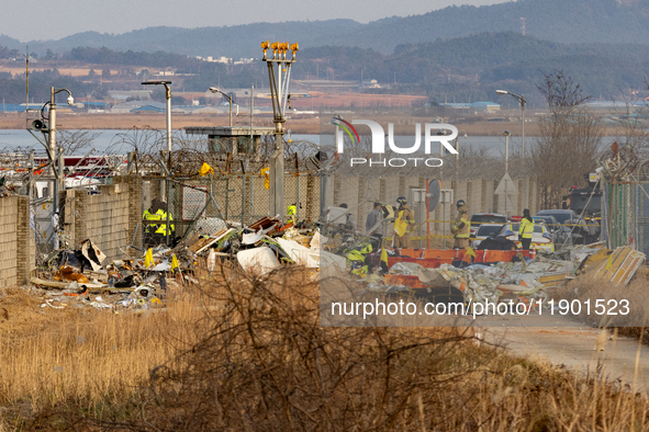 Fire authorities search for the missing and recover the deceased at the site of an accident near Muan International Airport in Jeollanam-do,...