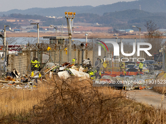 Fire authorities search for the missing and recover the deceased at the site of an accident near Muan International Airport in Jeollanam-do,...