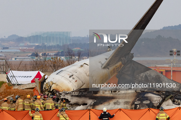 Fire authorities search for the missing and recover the deceased at the site of an accident near Muan International Airport in Jeollanam-do,...