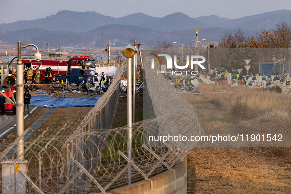 Fire authorities search for the missing and recover the deceased at the site of an accident near Muan International Airport in Jeollanam-do,...