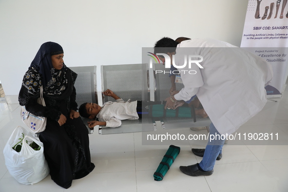 A doctor fits gaiters on a boy's limbs inside the Rehabilitation & Research Centre, a unit of Mahavir Seva Sadan, in Arambag on the outskirt...