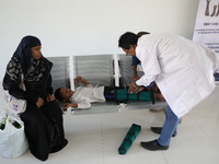 A doctor fits gaiters on a boy's limbs inside the Rehabilitation & Research Centre, a unit of Mahavir Seva Sadan, in Arambag on the outskirt...