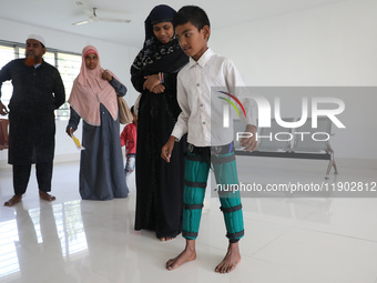 A boy tries to walk after being fitted with gaiters on his limbs inside the Rehabilitation & Research Centre, a unit of Mahavir Seva Sadan,...