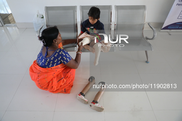 Nandani Dulai, a seven-year-old amputee, receives help from her mother inside the Rehabilitation & Research Centre, a unit of Mahavir Seva S...