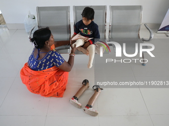 Nandani Dulai, a seven-year-old amputee, receives help from her mother inside the Rehabilitation & Research Centre, a unit of Mahavir Seva S...