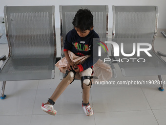 Nandani Dulai, a seven-year-old amputee, wears her prosthetic limbs inside the Rehabilitation & Research Centre, a unit of Mahavir Seva Sada...