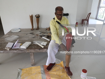 A man waits for his new prosthetic limb inside the Rehabilitation & Research Centre, a unit of Mahavir Seva Sadan, in Arambag on the outskir...