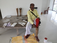 A man waits for his new prosthetic limb inside the Rehabilitation & Research Centre, a unit of Mahavir Seva Sadan, in Arambag on the outskir...