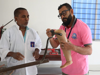 Workers examine a new prosthetic limb inside the Rehabilitation & Research Centre, a unit of Mahavir Seva Sadan, in Arambag on the outskirts...