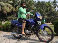 An amputee with a prosthetic limb rides a motorcycle outside the Rehabilitation & Research Centre, a unit of Mahavir Seva Sadan, in Arambag...