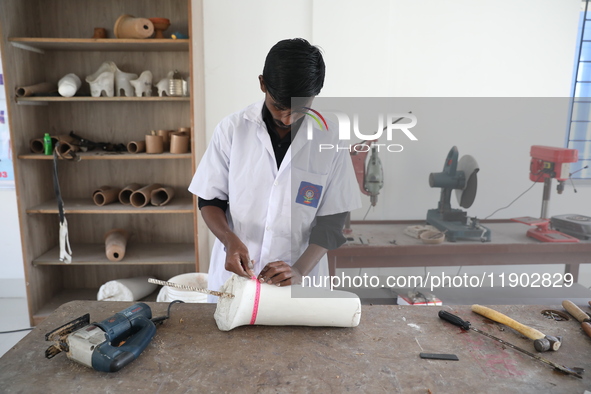 A worker measures a limb prosthetic inside the Rehabilitation & Research Centre, a unit of Mahavir Seva Sadan, in Arambag on the outskirts o...