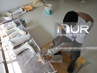 A worker manufactures a prosthetic limb inside the Rehabilitation & Research Centre, a unit of Mahavir Seva Sadan, in Arambag on the outskir...