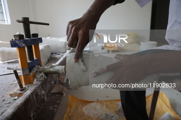 A worker manufactures a prosthetic limb inside the Rehabilitation & Research Centre, a unit of Mahavir Seva Sadan, in Arambag on the outskir...