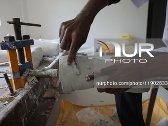 A worker manufactures a prosthetic limb inside the Rehabilitation & Research Centre, a unit of Mahavir Seva Sadan, in Arambag on the outskir...