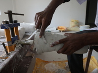 A worker manufactures a prosthetic limb inside the Rehabilitation & Research Centre, a unit of Mahavir Seva Sadan, in Arambag on the outskir...