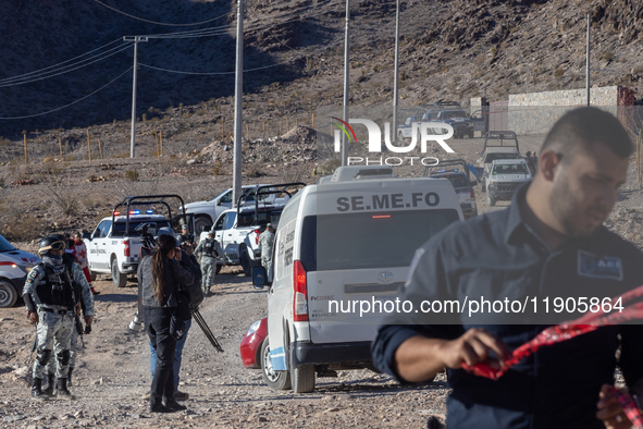 A Chihuahua state police officer places caution tape at the scene where an immigration officer loses his life after being attacked with rock...