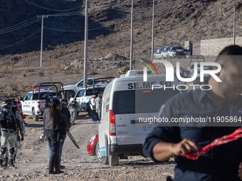 A Chihuahua state police officer places caution tape at the scene where an immigration officer loses his life after being attacked with rock...