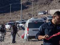 A Chihuahua state police officer places caution tape at the scene where an immigration officer loses his life after being attacked with rock...