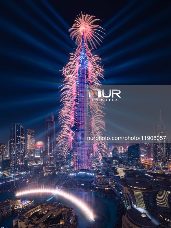 A light show and fireworks illuminate the Burj Khalifa, the world's tallest building, during New Year's Eve celebrations in Dubai on January...