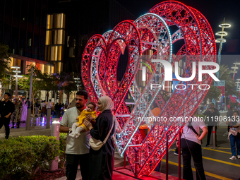 People take pictures at Lusail Boulevard during the 2025 New Year's Day celebrations in Doha, Qatar, on January 1, 2025. (