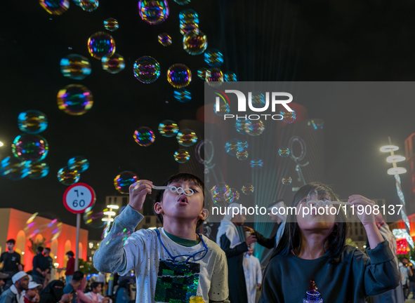 Children blow bubbles at Lusail Boulevard during the 2025 New Year's Day celebrations in Doha, Qatar, on January 1, 2025. 